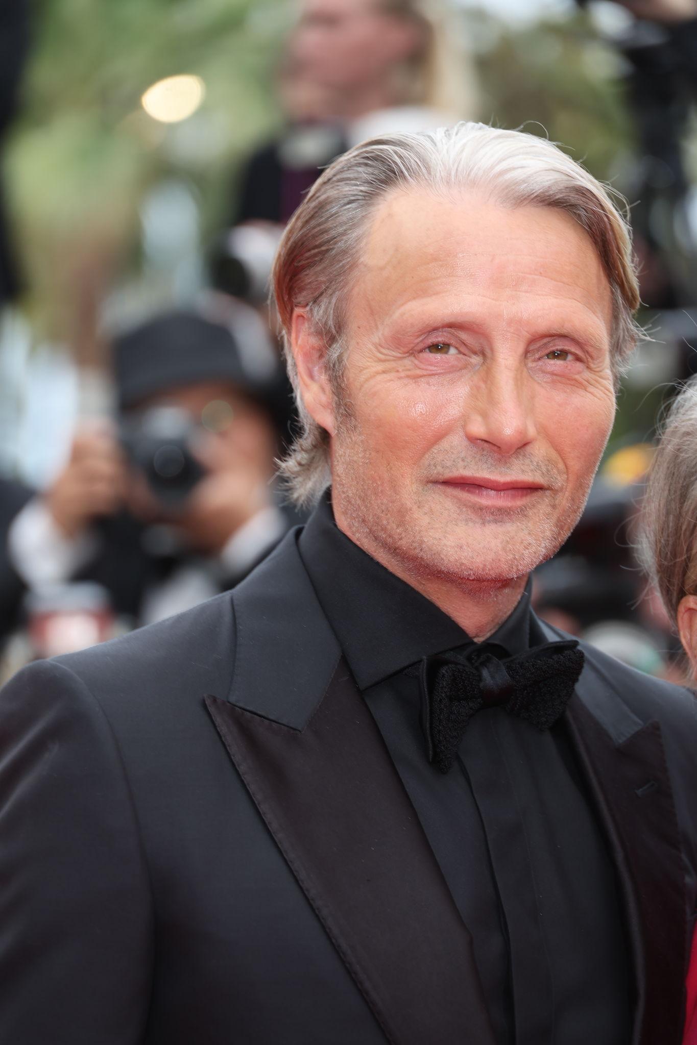 Mads Mikkelsen attending an international film festival in a classic black tuxedo.